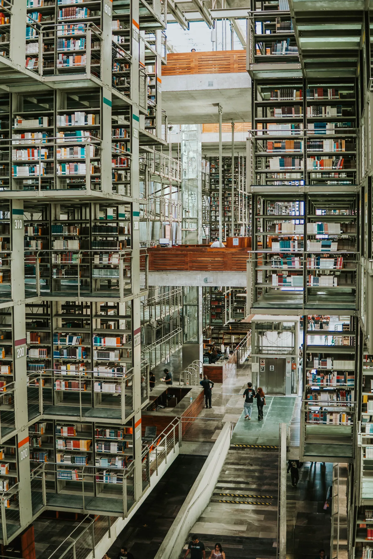 Rows of floating bookshelves stretching to the ceiling at Biblioteca Vasconcelos
