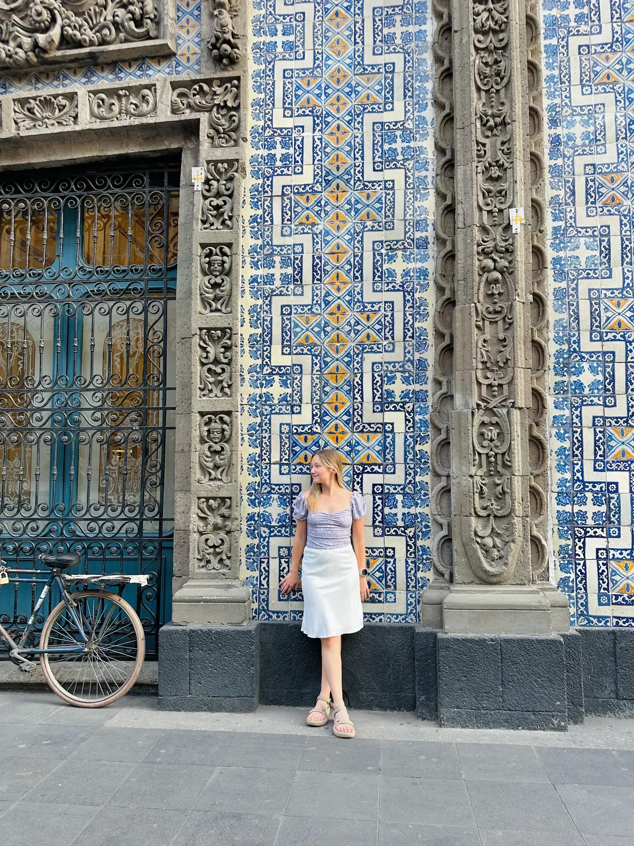 Posing in front of the blue tile facade of Casa de los Azulejos in CDMX