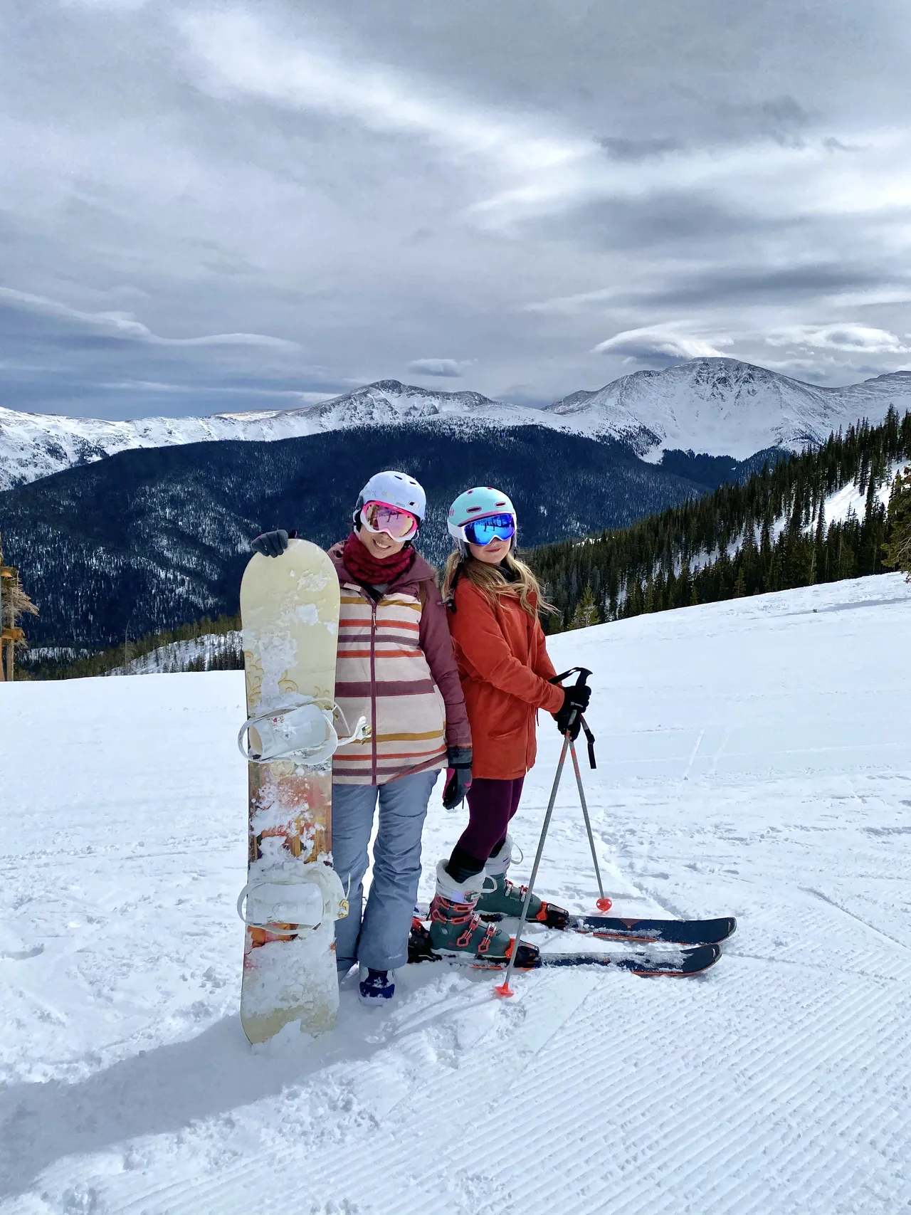 two girls snowboarding and skiing together at winter park colorado