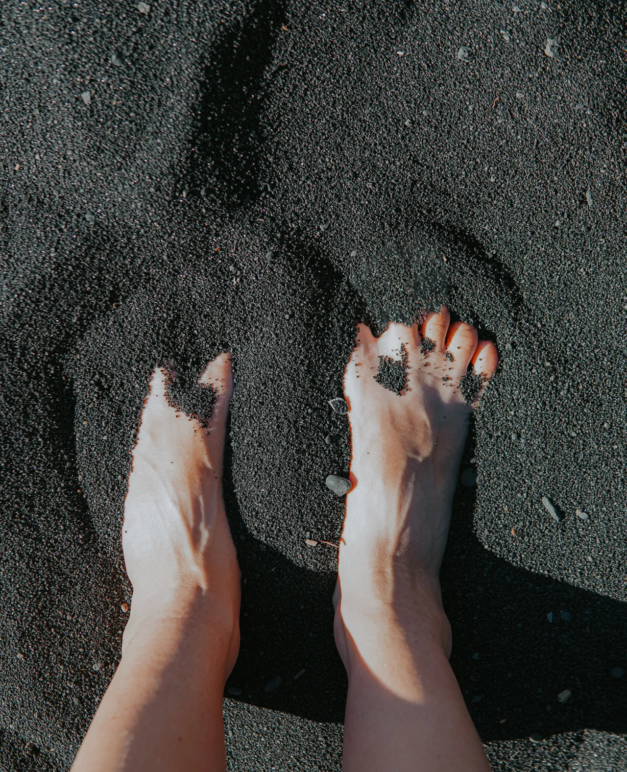 feet in black sand