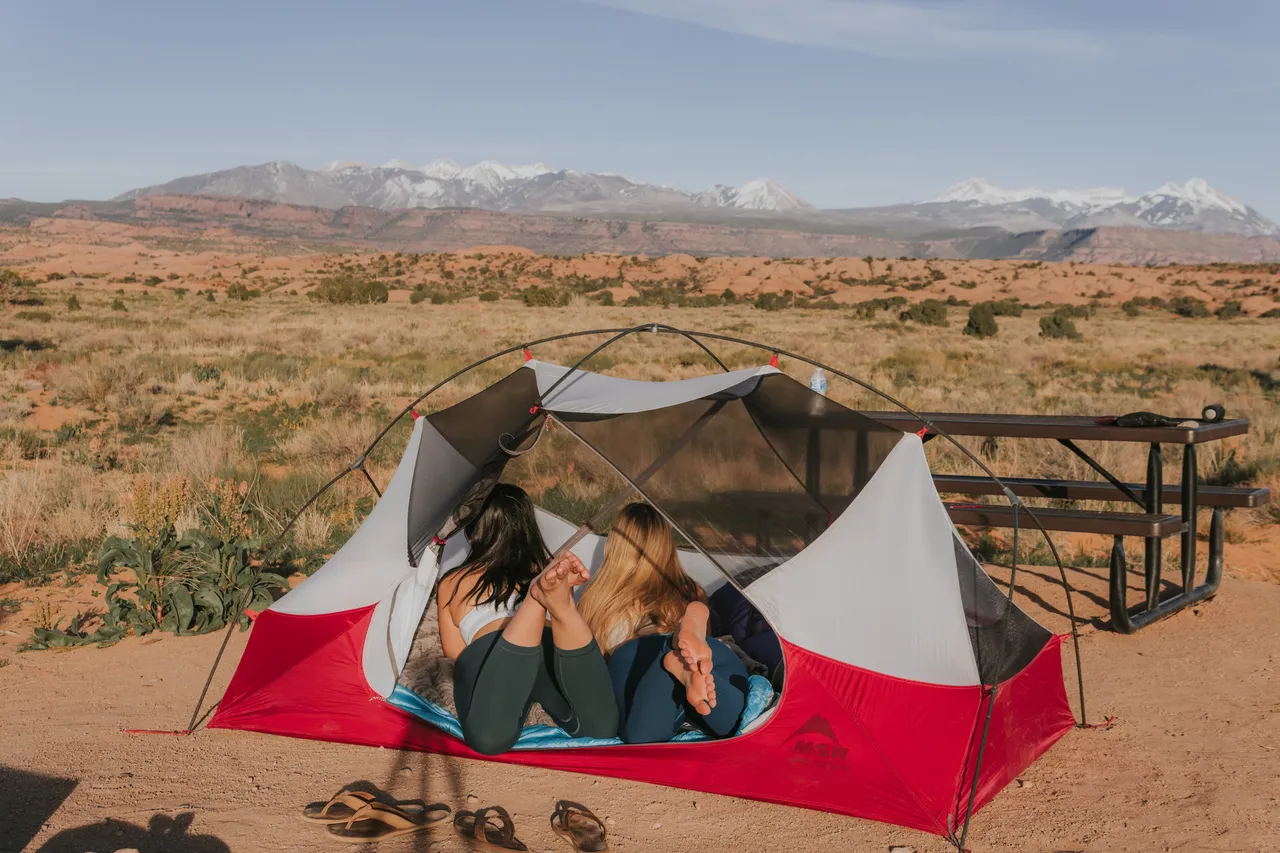 two girls laying down inside the MSR hubba hubba tent at sand flats recreation area