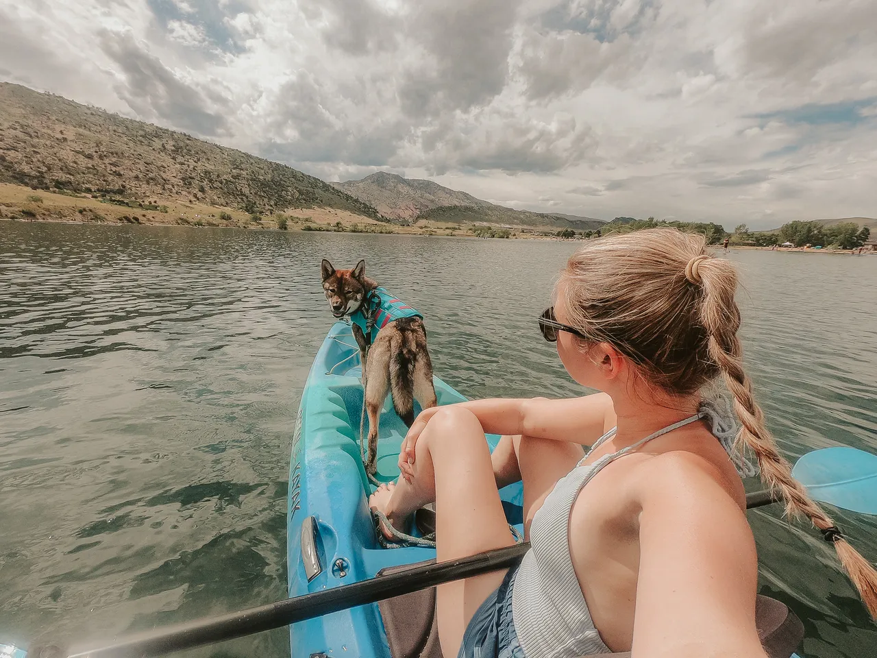 a girl kayaking with her dog in colorado