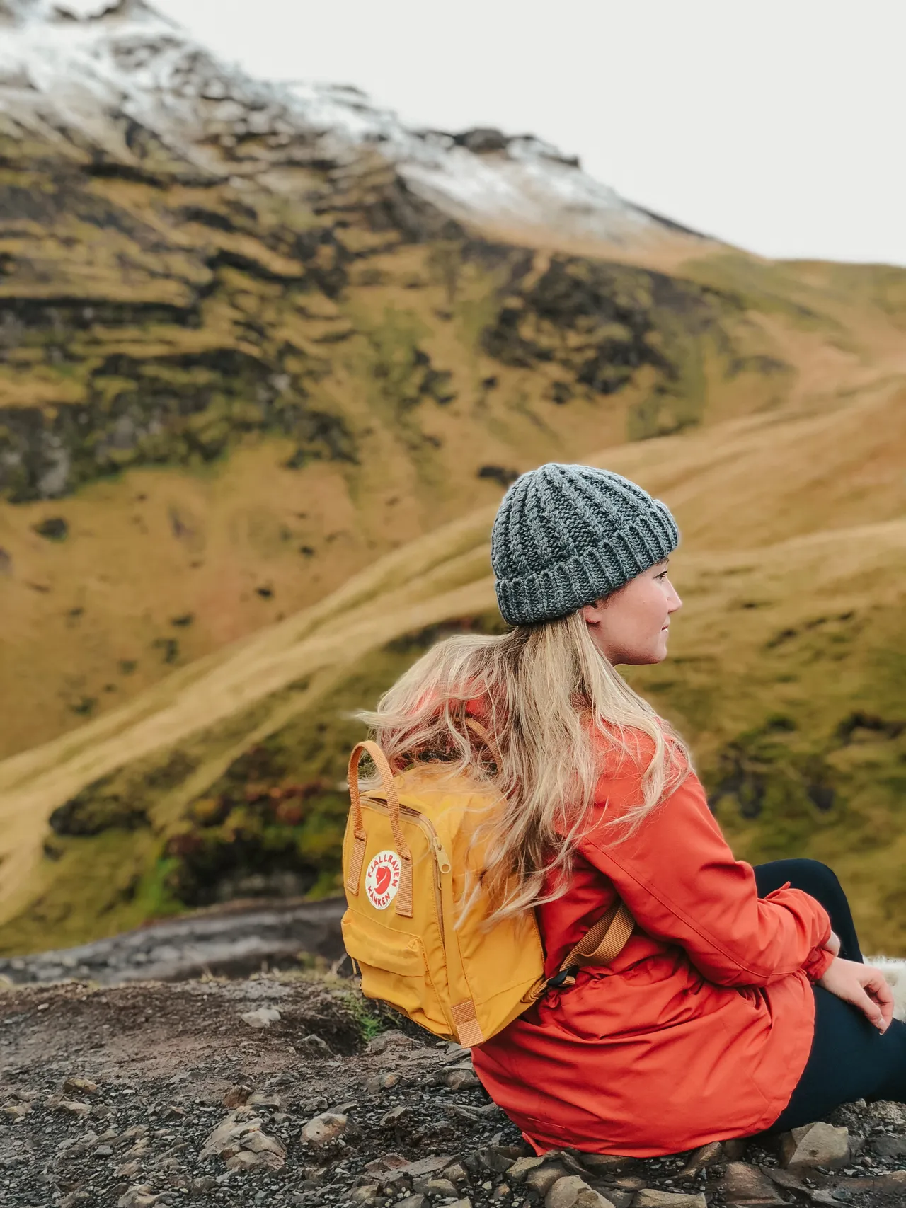 Girl wearing Yellow Kanken backpack while hiking
