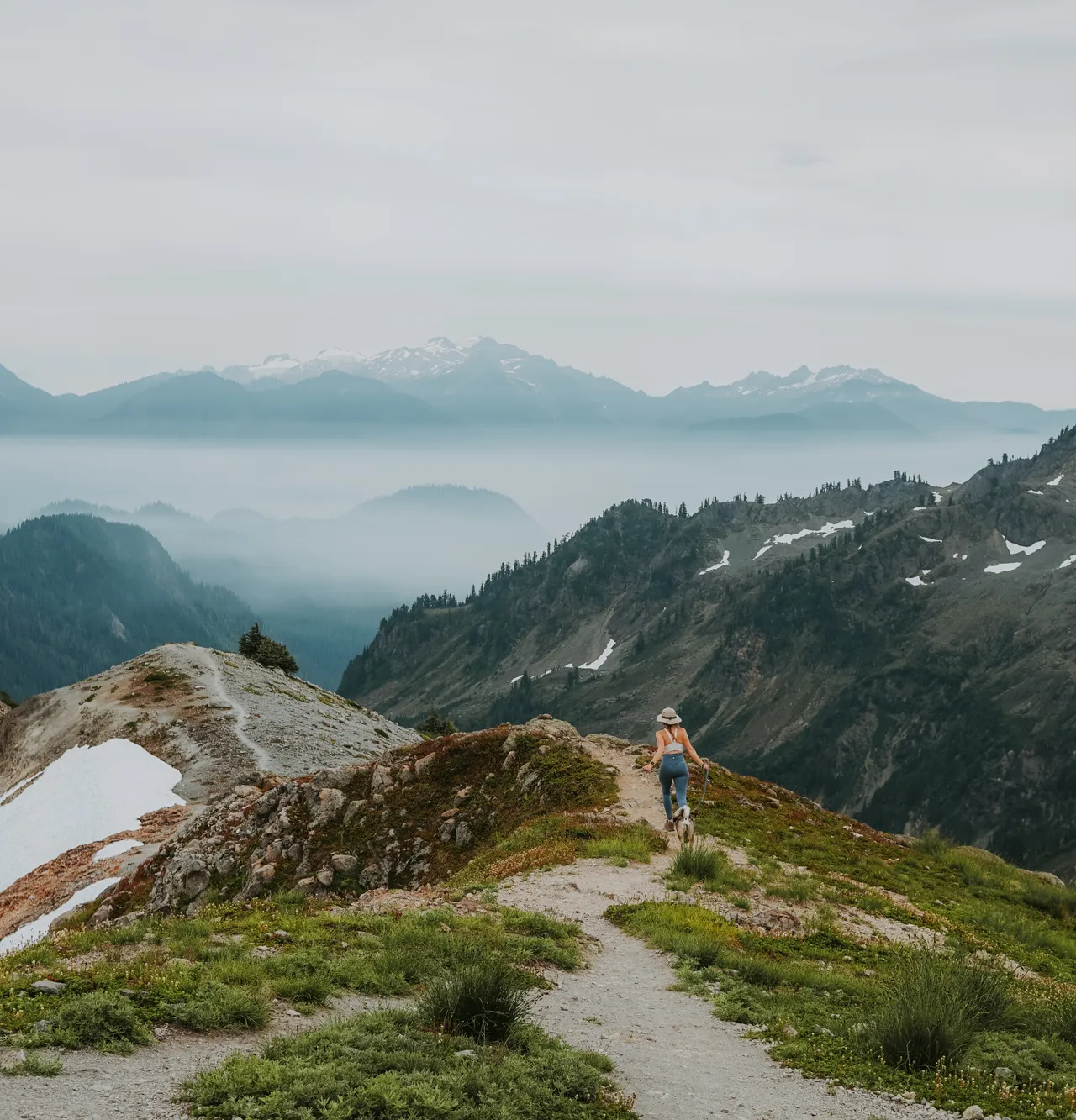 a girl and her dog running at Ptarmagin Trail
