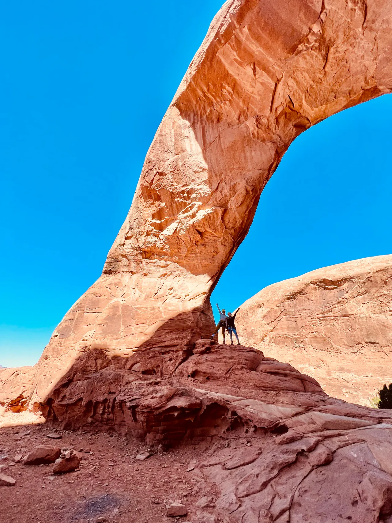 two girls posing in front of funnel arch