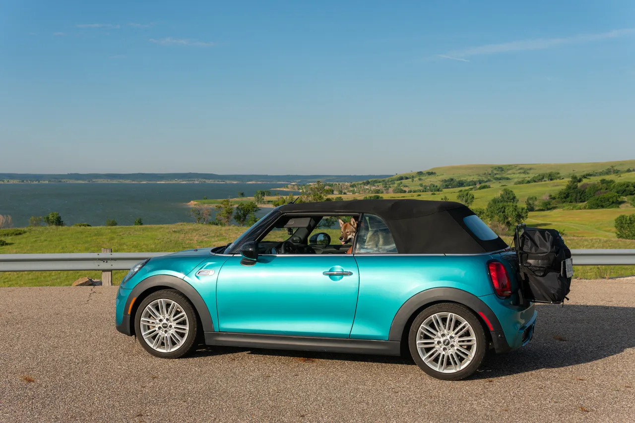 Teal MINI Cooper convertible on the road during the move to Colorado