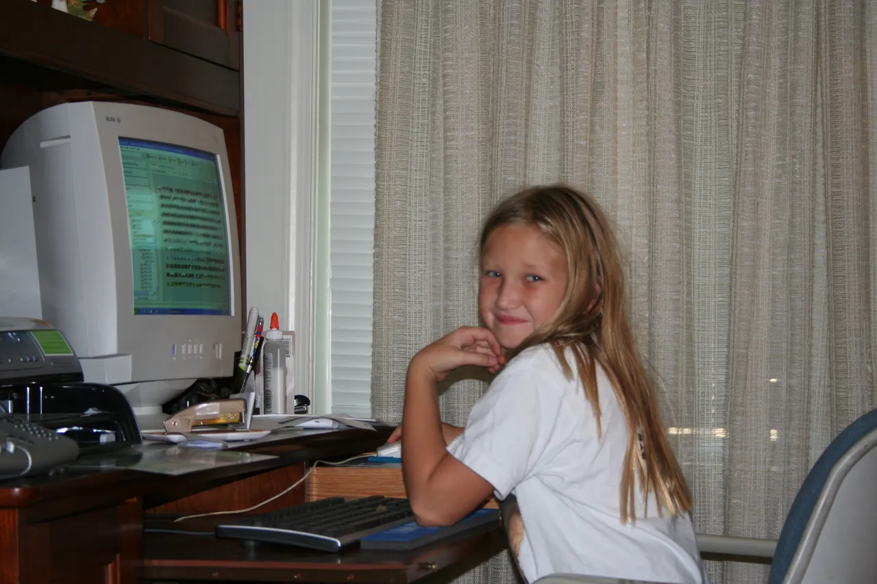 10-year-old me at the computer editing photos in 2005