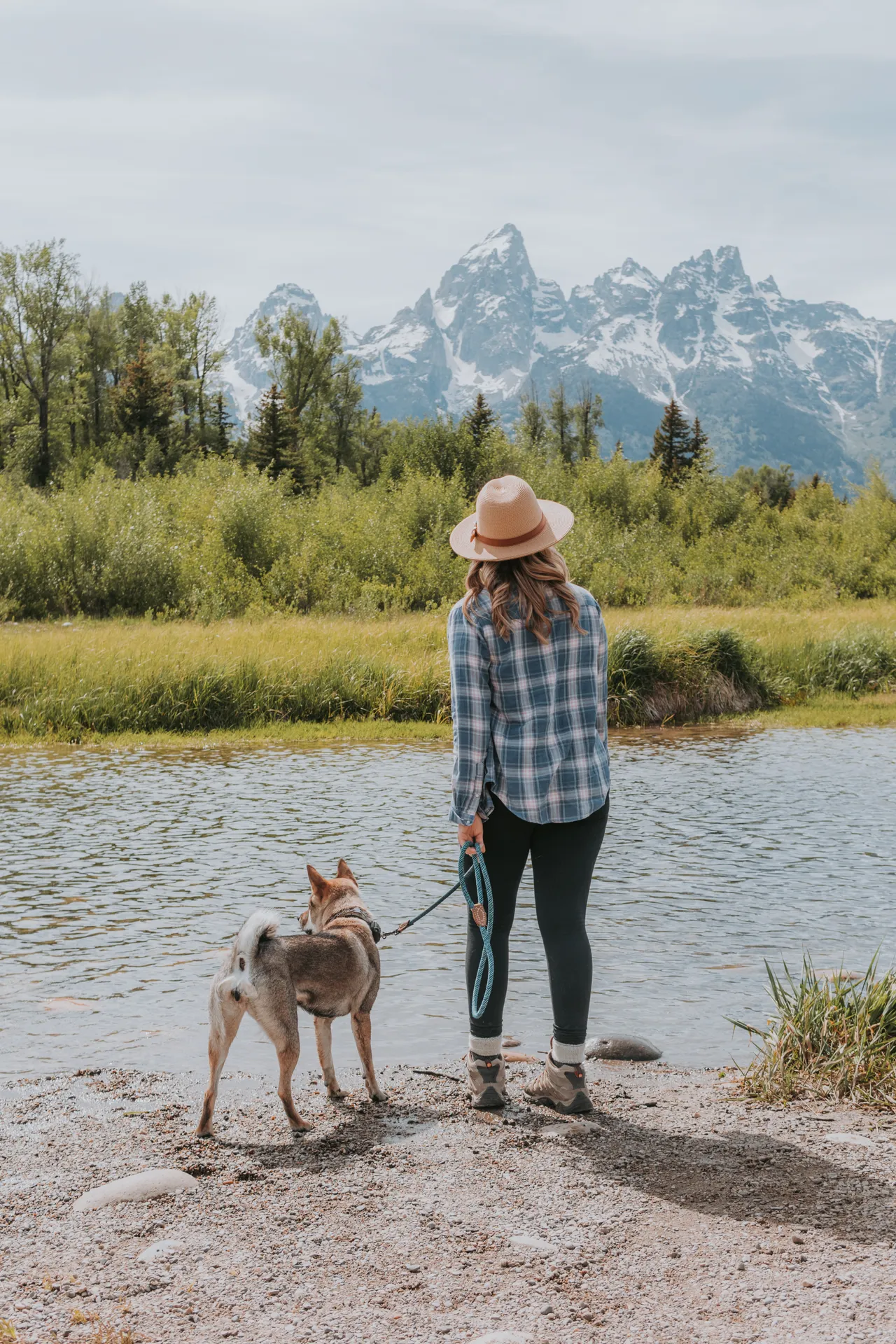Wide-brim hat and plaid at Grand Teton with Sora by the river