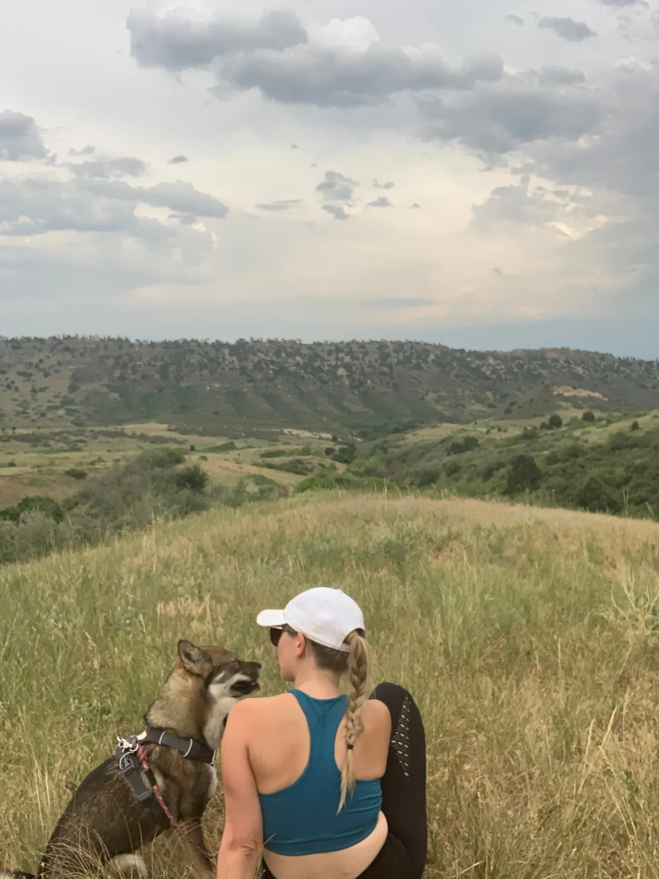 Crouching with Sora on a hilltop overlooking the Colorado foothills