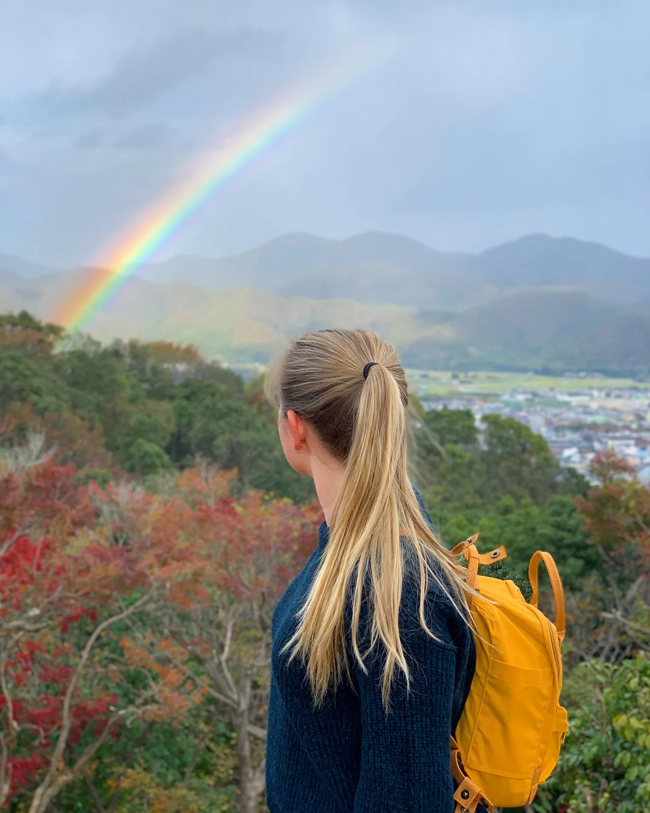 Looking out to the Kyoto mountains at a rainbow in the fall