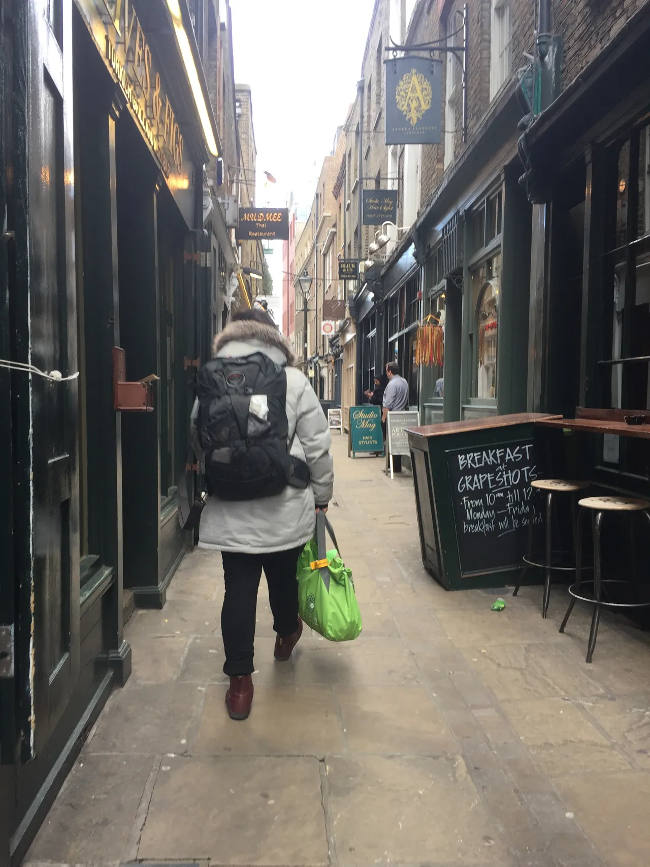 Exploring a London alleyway with just a backpack