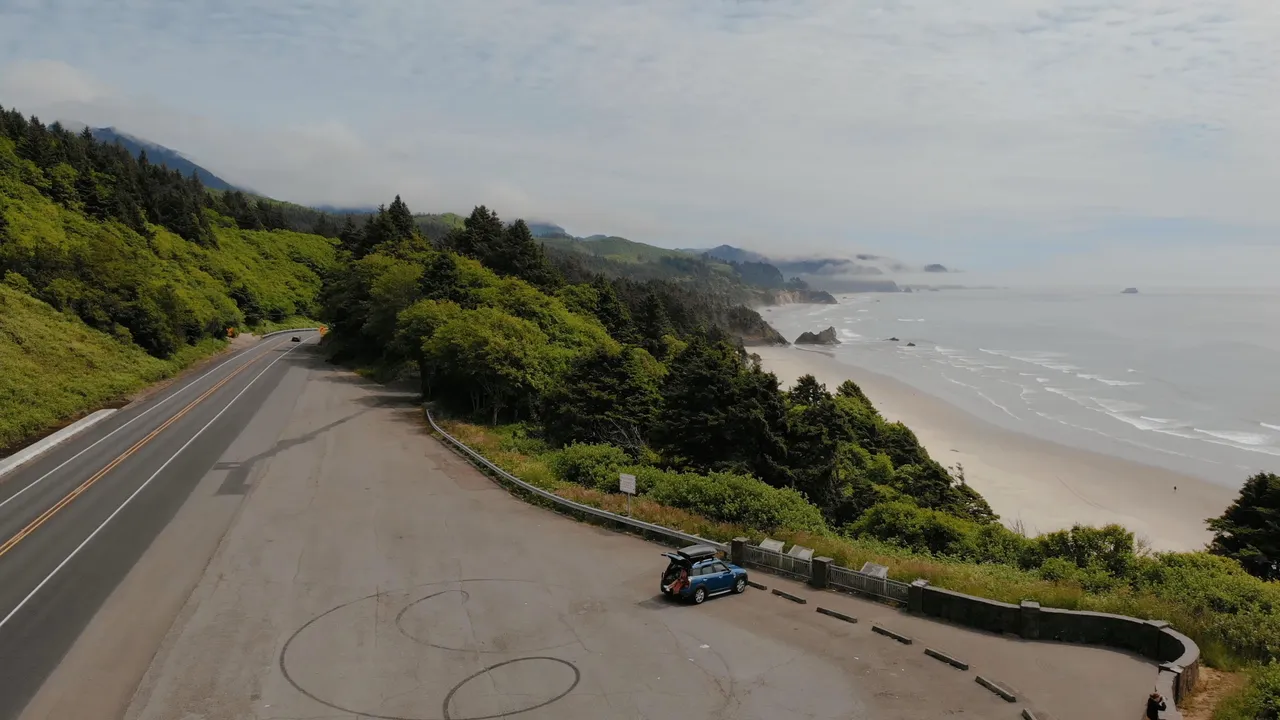 Aerial view of the blue MINI Cooper parked at a coastal overlook on the Oregon coast