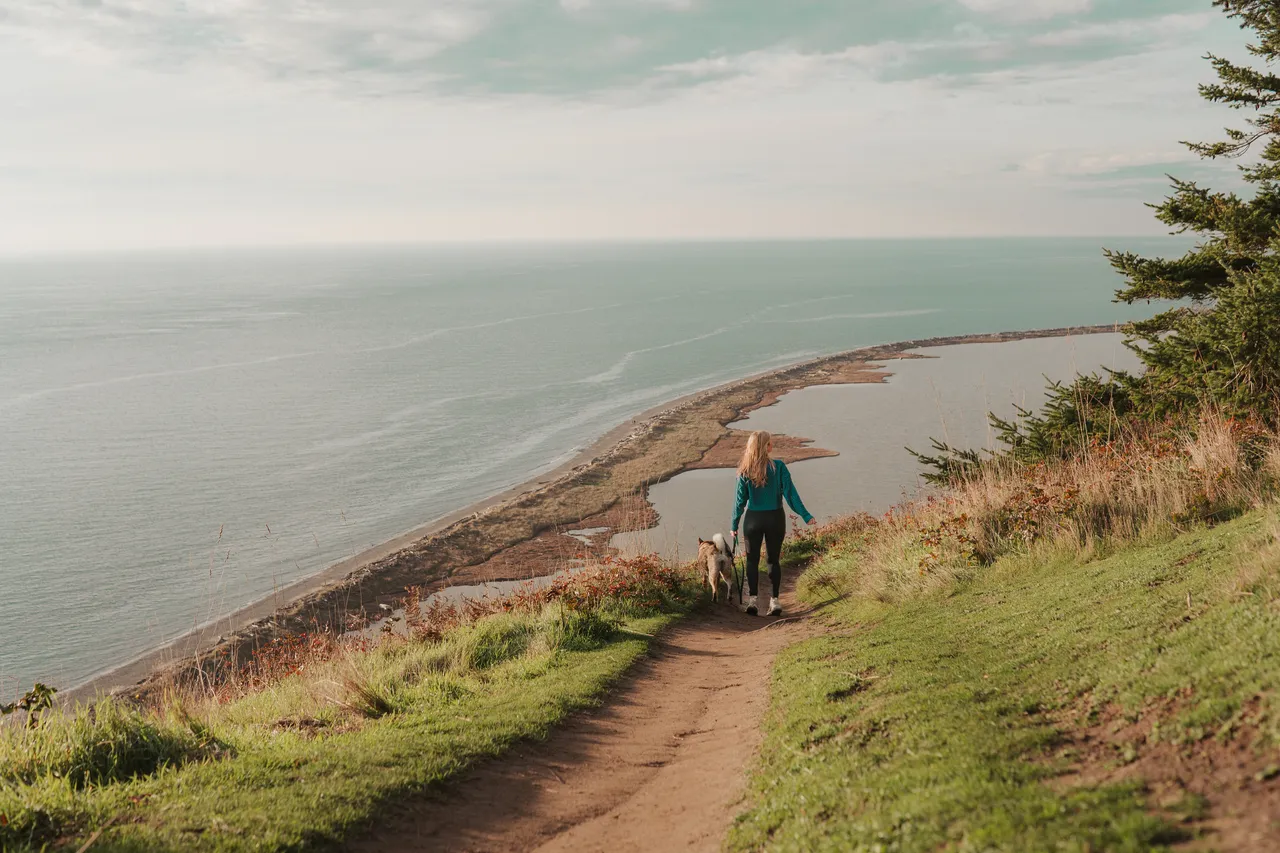 Hiking a cliffside trail with Sora overlooking the coastline on a Pacific Northwest island