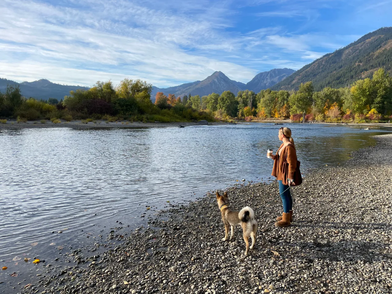 Standing with Sora by a river in the Cascade foothills with fall colors and mountains, Washington