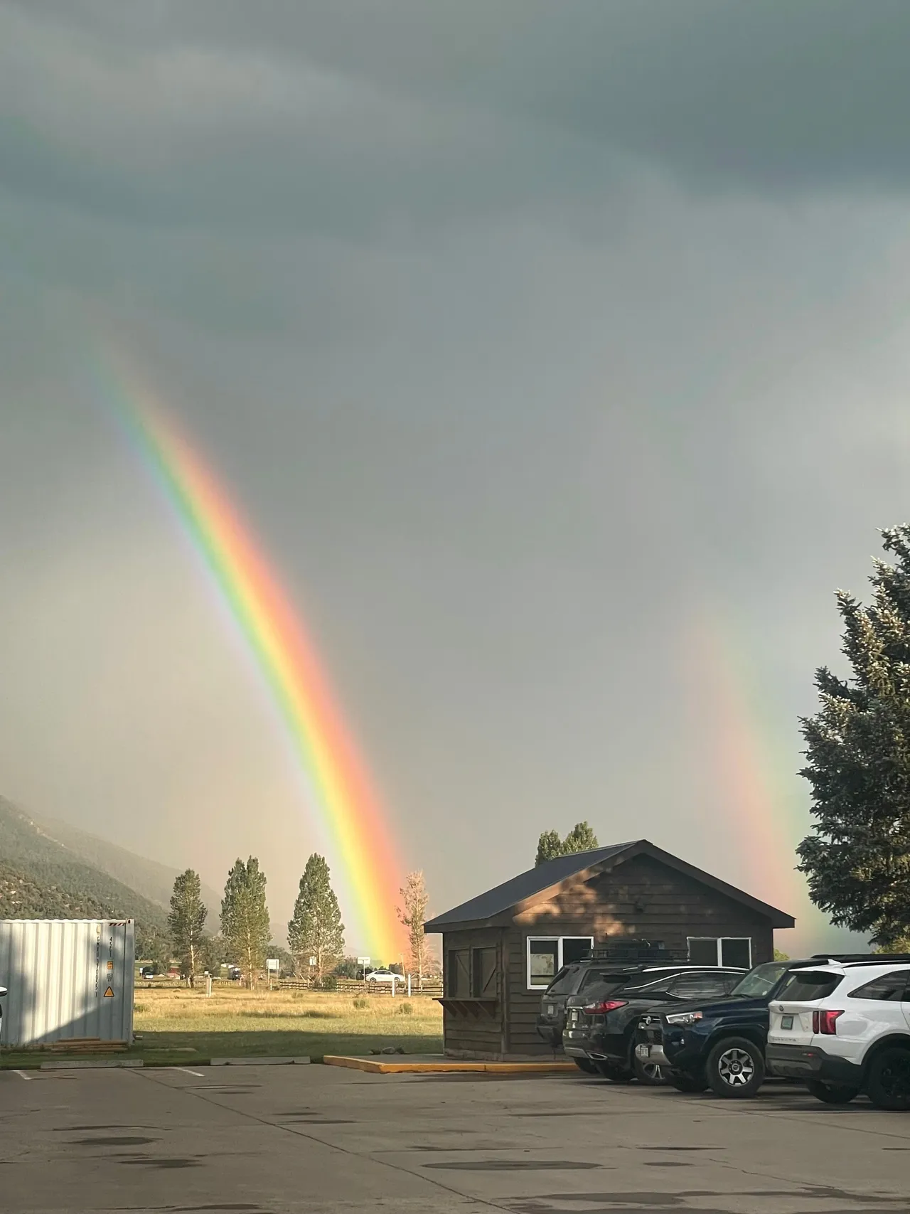 Double rainbow over Ridgway, Colorado with the MINI Cooper parked outside
