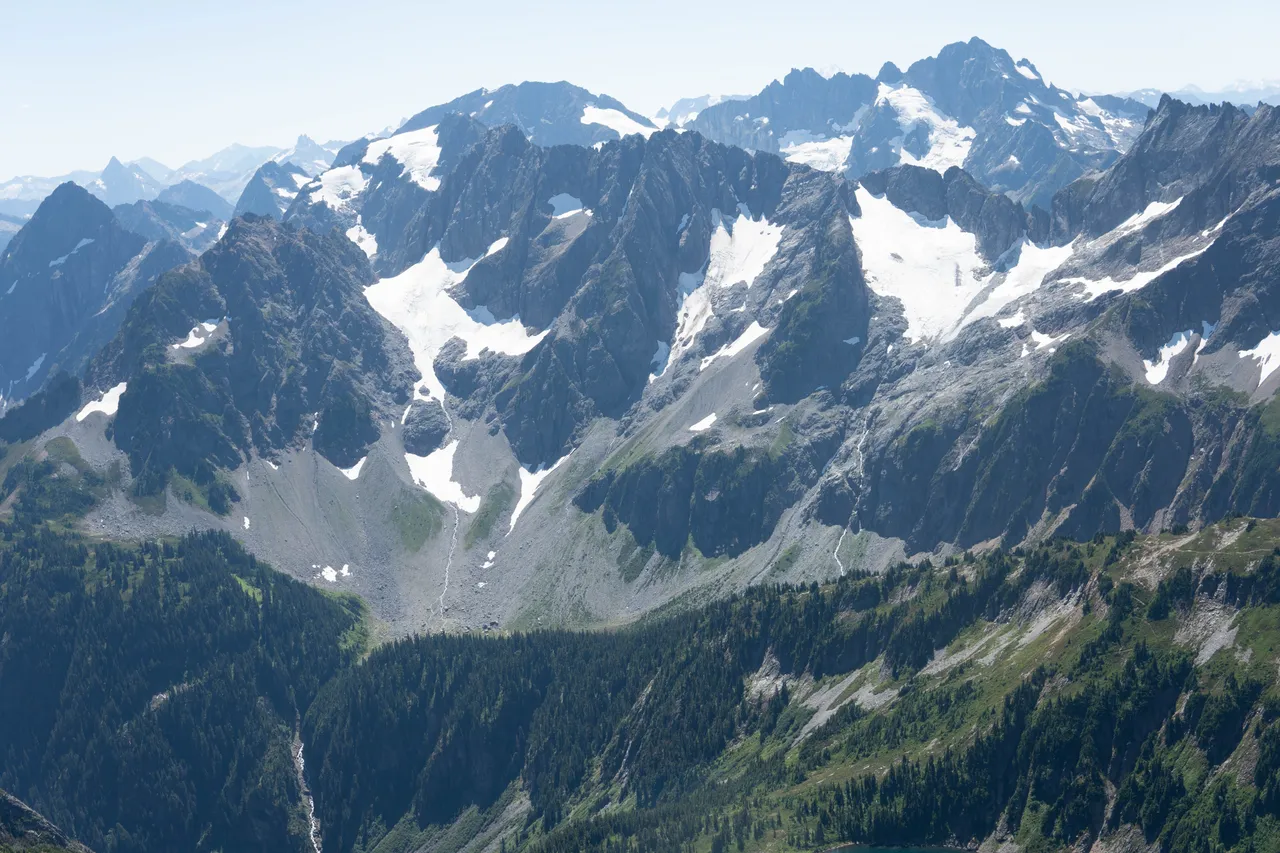 Panoramic view of snow-capped North Cascades peaks from the Sahale Arm summit
