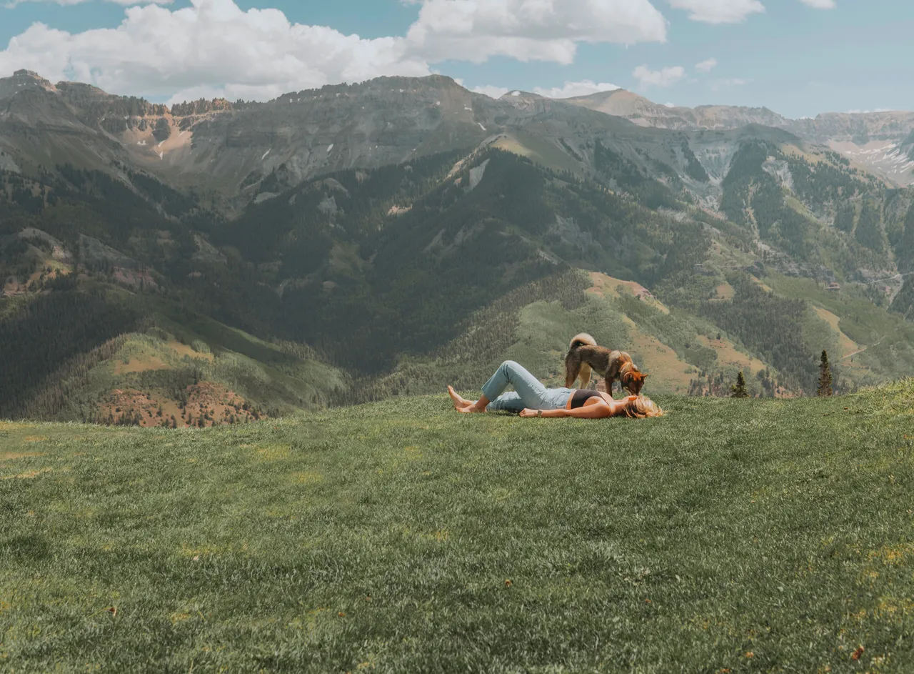 Laying in the grass on a mountaintop with Sora and the San Juan Mountains stretching out behind us