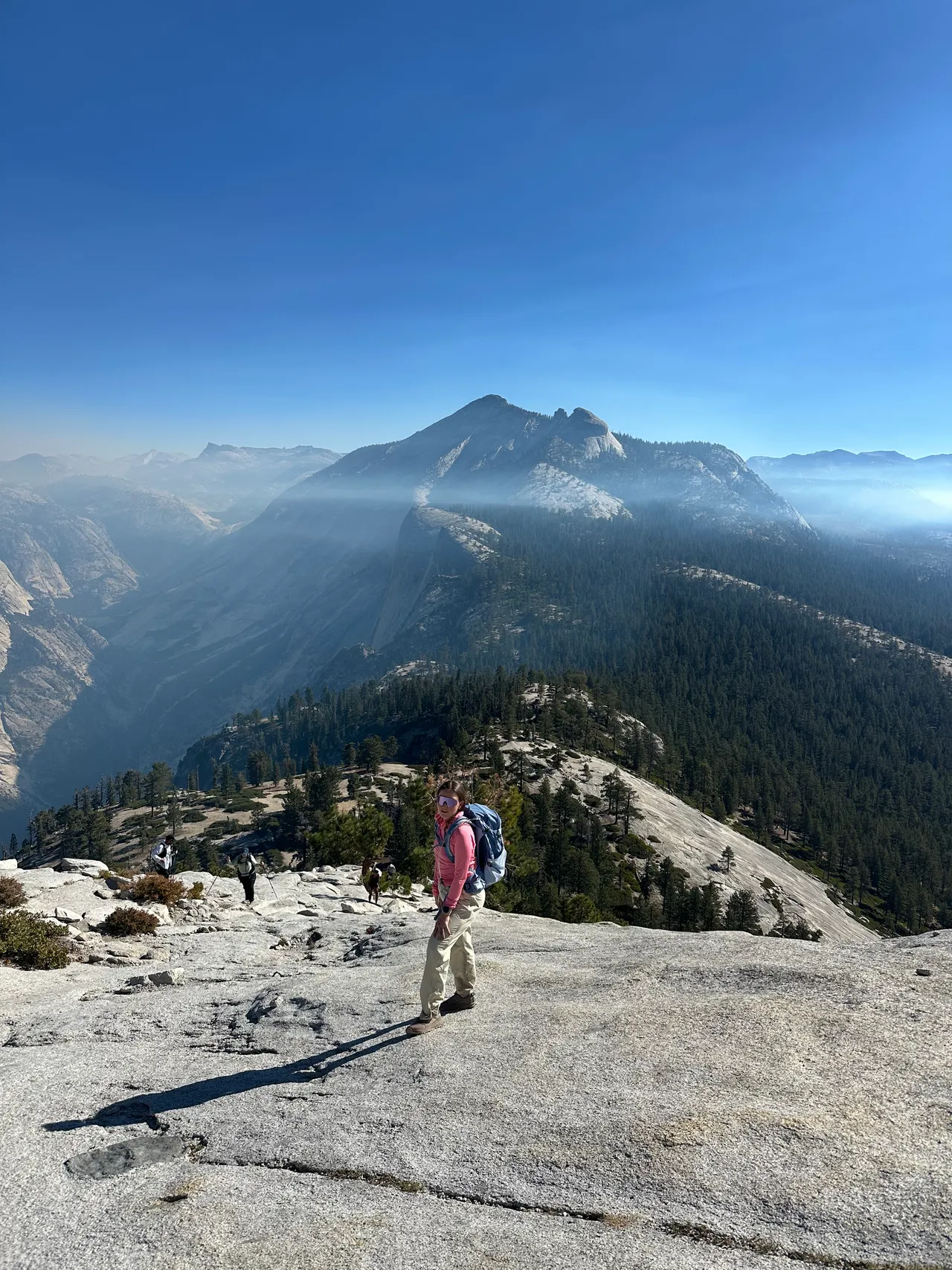 On the granite of Sub Dome with hazy Yosemite mountains behind me
