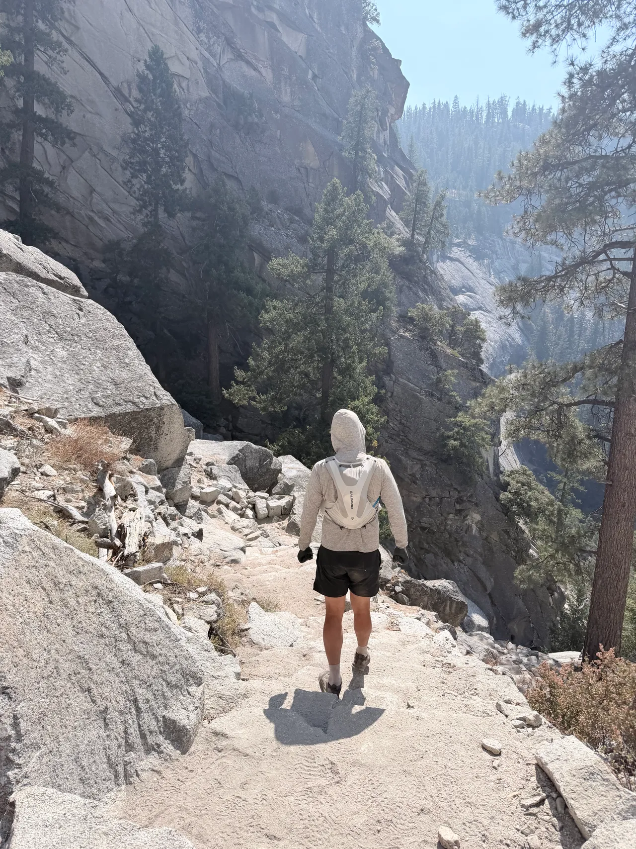 A hiker descending the granite steps of the Mist Trail