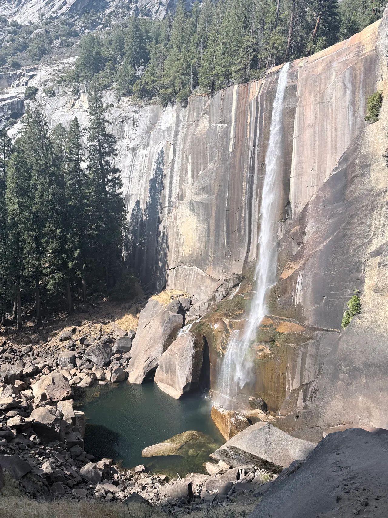 A waterfall dropping down a granite cliff in Yosemite